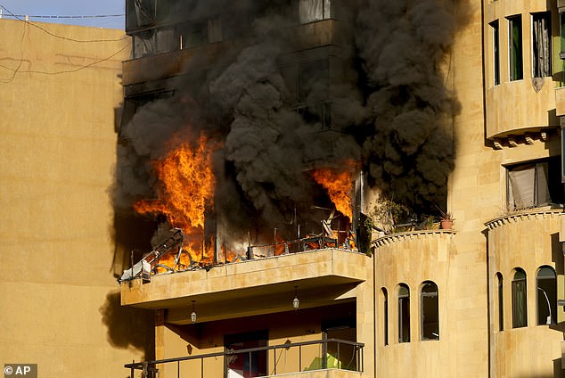 Flames rise from an apartment that caught fire after an Israeli airstrike in Dahieh, Beirut, Lebanon, Wednesday, October 2, 2024.