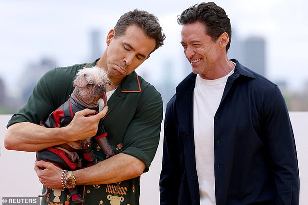 Cast members Hugh Jackman and Ryan Reynolds, holding Peggy, Britain's ugliest dog.