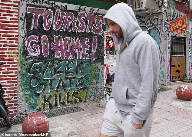 A chilling graffiti in Athens reads: 'Tourists are going home! The Greek state kills