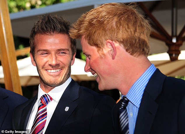 Prince Harry smiles with David Beckham at a 2010 FA reception in South Africa