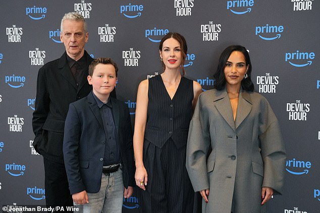 The brunette beauty posed confidently as she graced the carpet with co-stars Peter Capaldi, Benjamin Chivers and Saffron Hocking (pictured left to right).