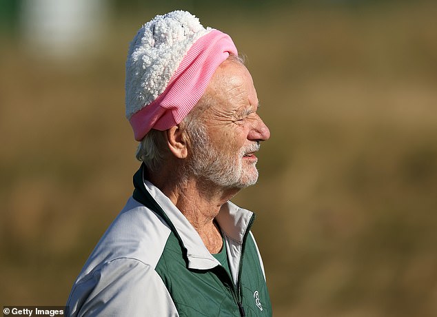 Bill bundled up for the round of golf in a pink winter hat which he paired with a green sweater and black pants.