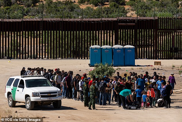 Migrants wait to be processed by U.S. Border Patrol agents after crossing into the U.S. from Mexico on June 14, 2024 in Jacumba Hot Springs, California. FEMA has received more than $1 billion to house noncitizens since 2023