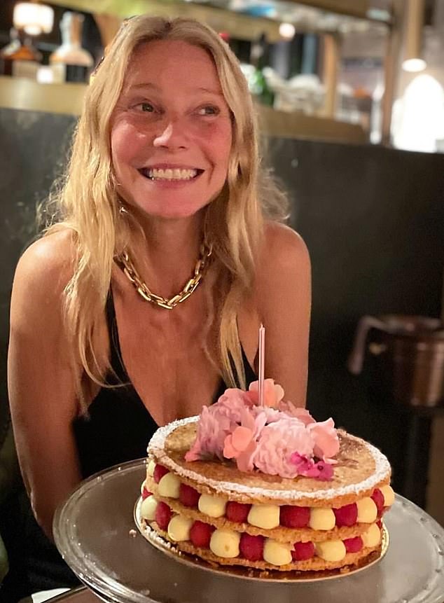 Gwyneth Paltrow shared this photo online of her posing at a local brasserie with a layered birthday cake.