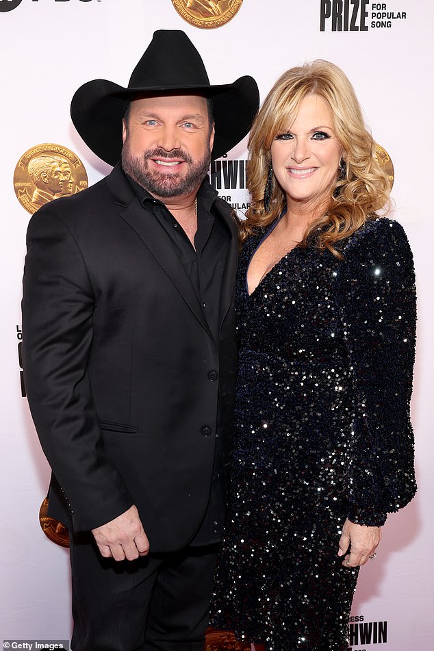 The country star was accused of sexual assault and battery in a complaint filed Thursday in California state court by a makeup artist who worked for his wife Trisha Yearwood; seen with Trisha in March