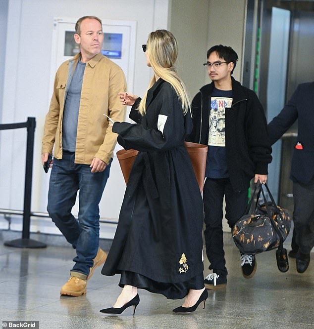 Maddox, who was adopted from an orphanage in Cambodia in 2002, walked out the door dressed all in black, consisting of tight pants, a T-shirt, a zip-up jacket and sneakers.