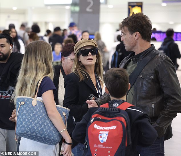 Natalie, 50, and Cameron, 49, were spotted at Sydney Airport on Thursday with their two children, Harper, 14, and Hendrix, 11.