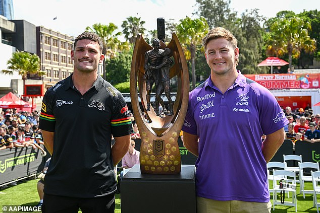 Pictured: Captains Nathan Cleary and Harry Grant pose with the premiership trophy.