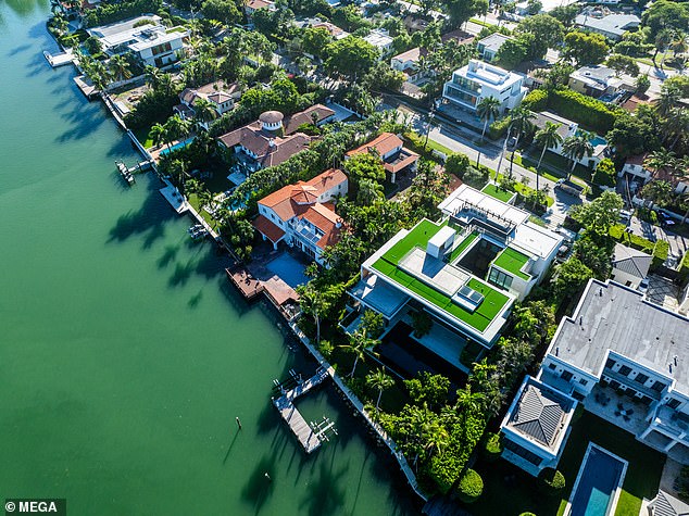 Outside, the property features an outdoor kitchen, a rooftop lounge and 124 feet of Biscayne Bay frontage.