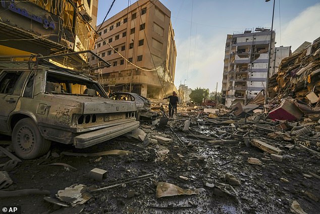 Residents run for shelter after an Israeli airstrike in Dahiyeh, Beirut, Lebanon, Friday, October 4, 2024.