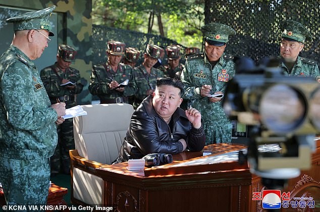 Kim Jong Un speaks with military officers at a special forces training base in North Korea's western region.