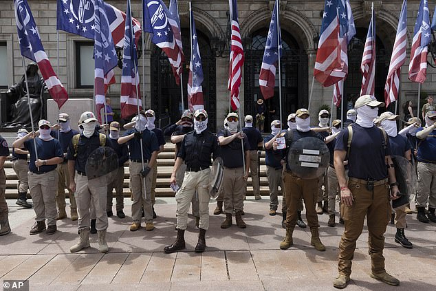 The group is photographed in front of the Boston Public Library carrying flags, near where Murrell was attacked.