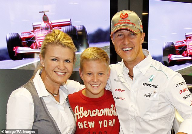 Mick, pictured with his mum Corinna (left) and dad Michael (right), grew up in the world of racing.