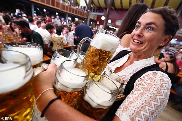 A waitress carries beers in the Paulaner tent on the opening day of Oktoberfest, September 21.