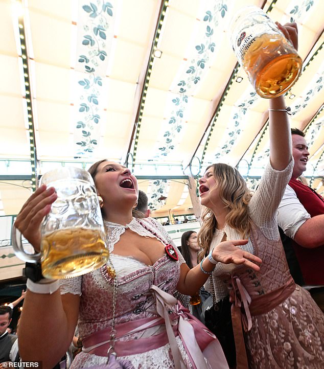 Visitors applaud and celebrate on the official opening day of the 189th Oktoberfest