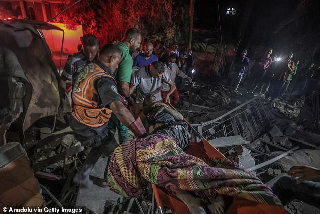 Civil defense members rescue injured people from the rubble of a building after Israeli strikes hit the Jaber family home in Deir Al Balah, Gaza, October 4, 2024.