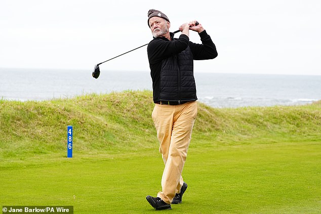 With his bobble hat at a jaunty angle, he concentrated on his swing.