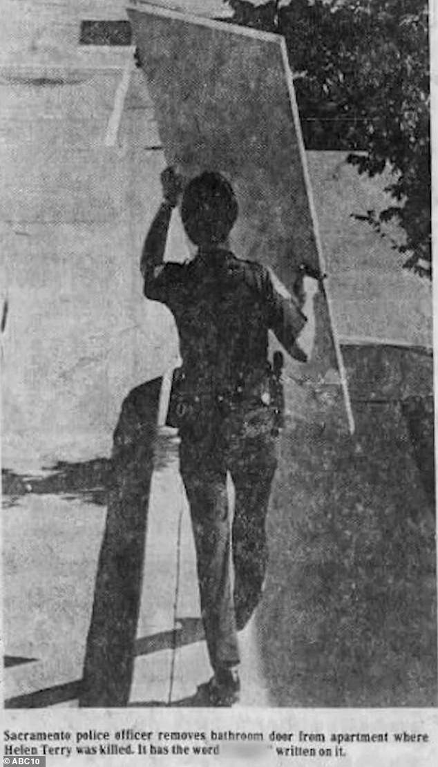 A newspaper clipping of a Sacramento police officer removing the bathroom door of the apartment where Terry was killed. The racial slur that was written on the wall was silenced in the news clipping.