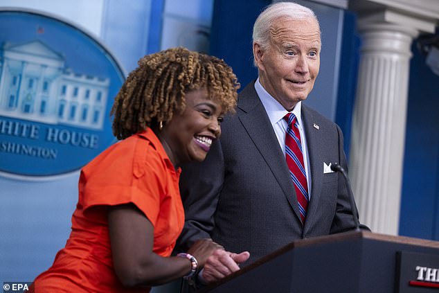 White House Press Secretary Karine Jean-Pierre (left) hugs President Joe Biden (right) during his surprise appearance at Friday's briefing.