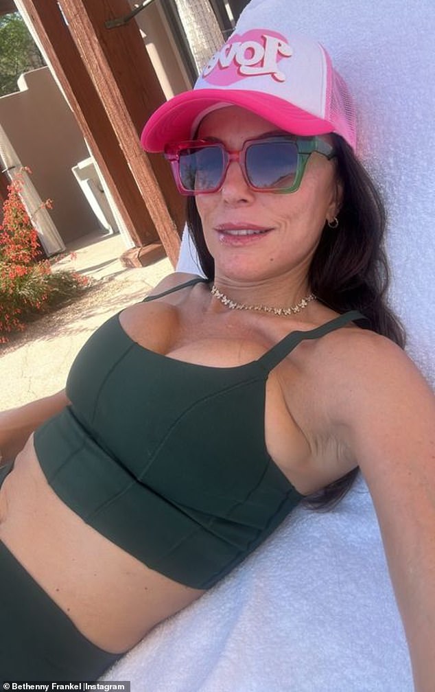 Frankel, 52, flaunted her abs again in a second snap as she relaxed on a lounger in a hunter green bra and matching pants.