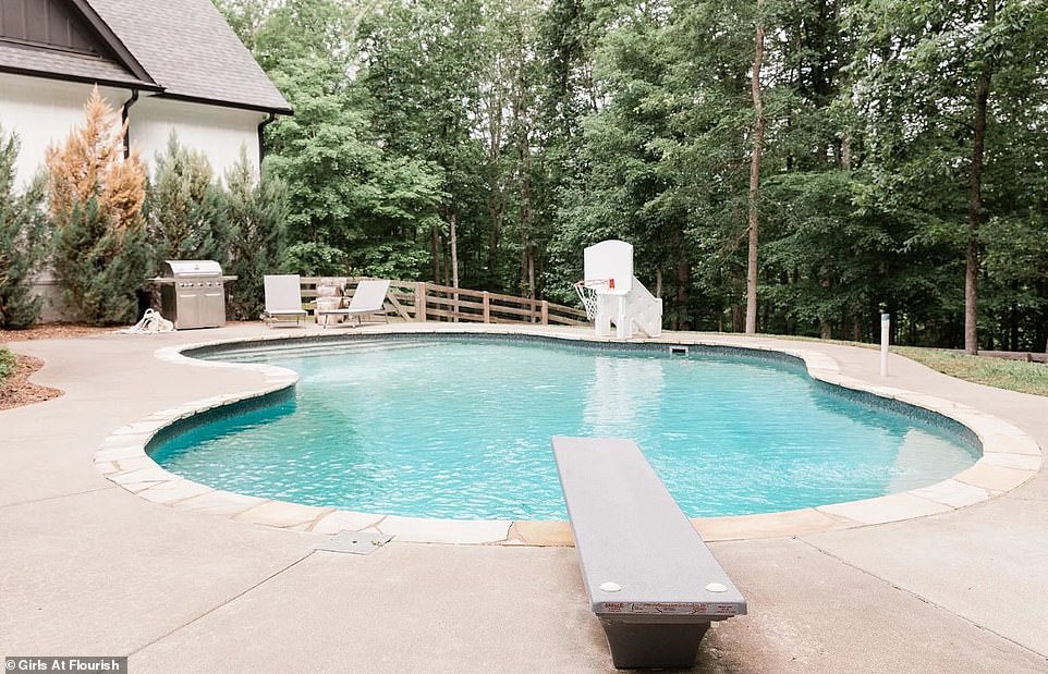 There was also a swimming pool with a diving board in the backyard.