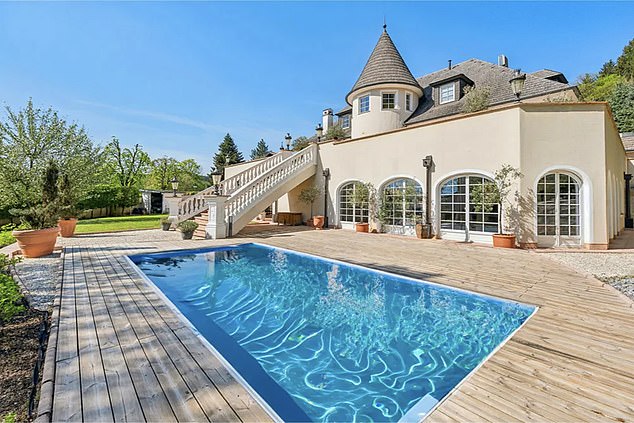 There is another swimming pool located outdoors in the large garden of the five-bed property.