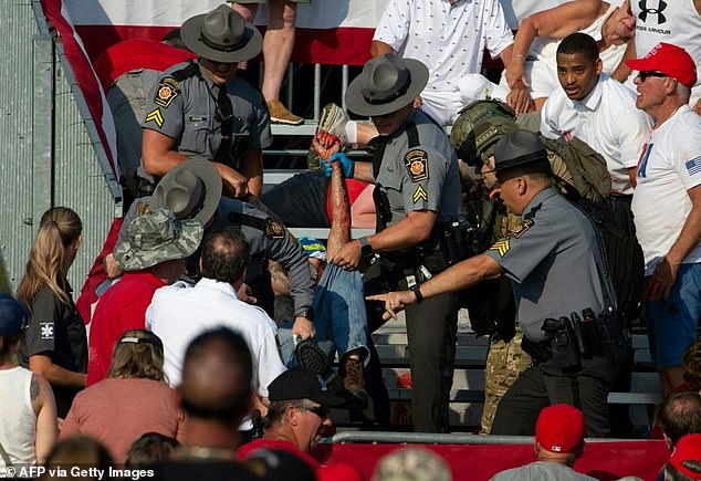 Comperatore is removed from stands by state police after weapons are fired at Trump