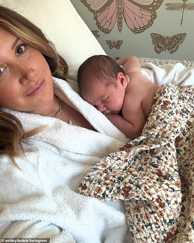 The post ended with Ashley taking a selfie in a white robe while Emerson napped next to her.