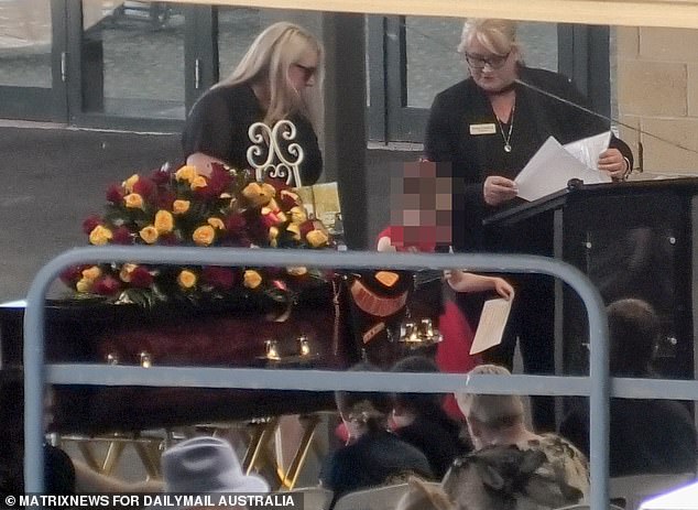 At the funeral procession, one of Mr. Martin's young daughters paid tribute to her father right in front of his coffin, which had been propped up and decorated with flowers.