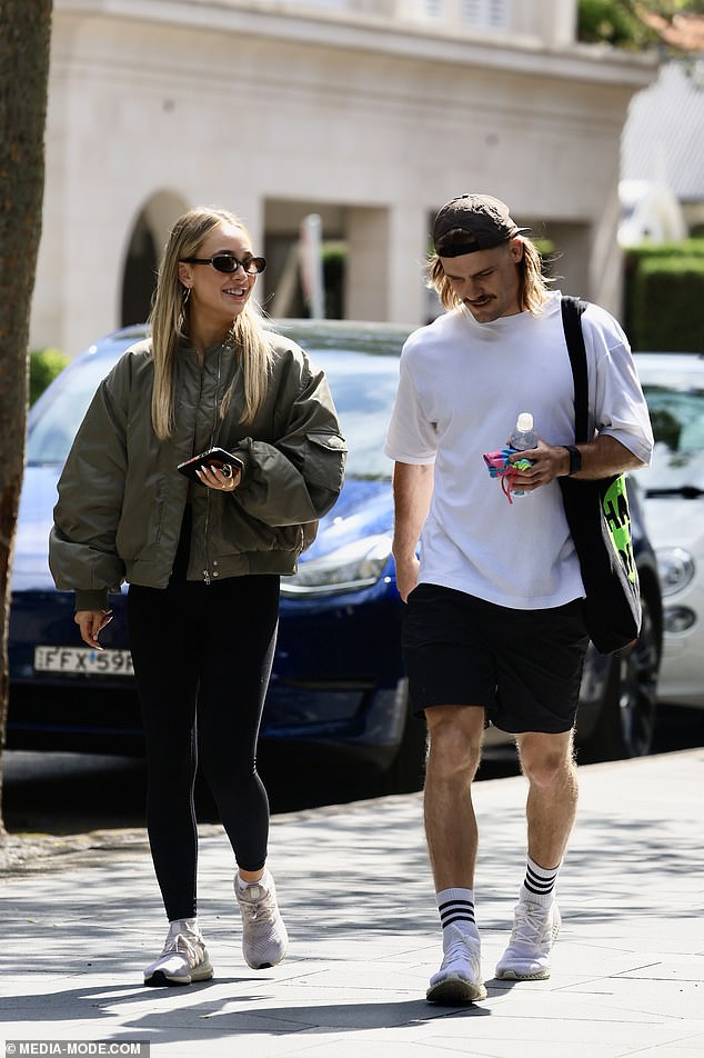 Ryan was taking advantage of the sunny October morning in Sydney, wearing a plain white t-shirt and a pair of plain black shorts.