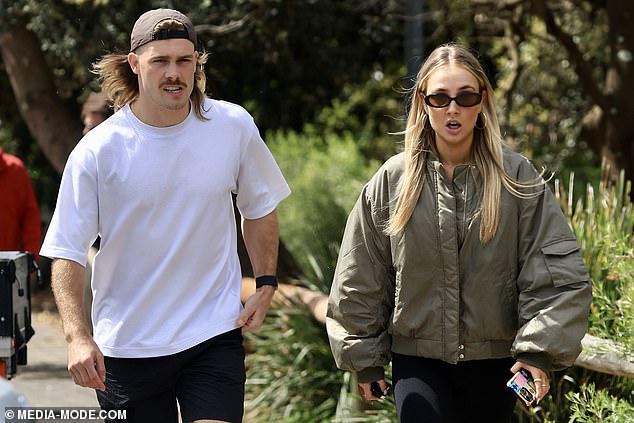 The couple seemed happy to be in each other's company, smiling as they walked down a tree-lined Sydney street.