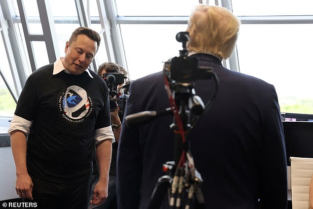 Elon Musk takes a small bow of his head as US President Donald Trump congratulates him in firing room four after the launch of a SpaceX Falcon 9 rocket and the Crew Dragon spacecraft on the SpaceX Demo-2 mission from NASA to the International Space Station from NASA's Kennedy Space Station. Center at Cape Canaveral, Florida, USA May 30, 2020