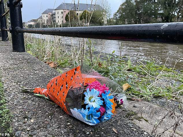 Laying flowers near the spot on the Cleddau River where the group died after finding themselves in trouble