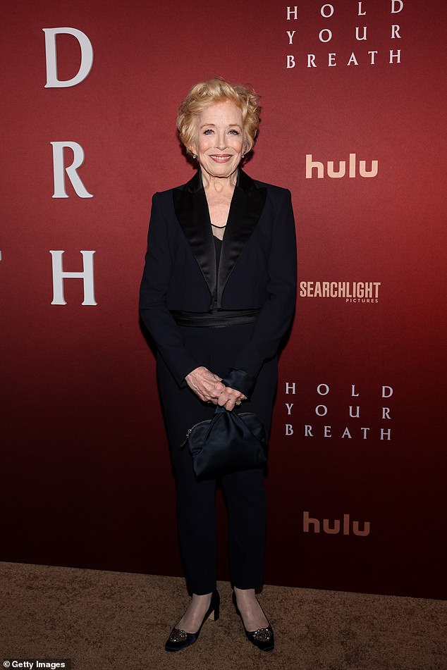 Holland opted for a sleek black suit with shiny lapels and a mesh neckline.