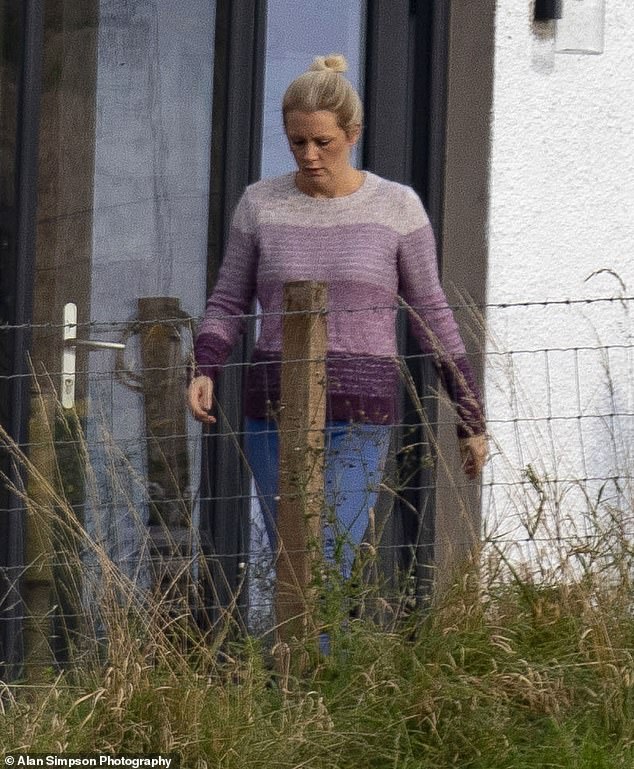 Sprung pictured outside the couple's three-bedroom semi-detached house near Dumfries today