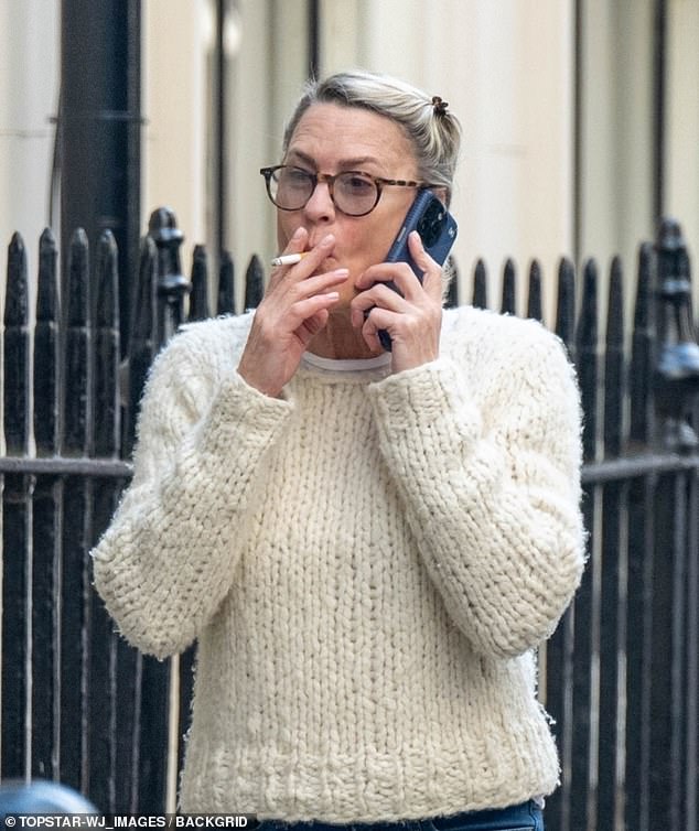 Wright sported a cream cable-knit sweater paired with stylish faded jeans, looking engrossed in a phone conversation as she chatted animatedly as she walked down the sidewalk.