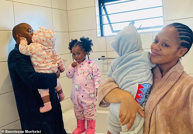 Basetsana (right) holds Blessing while her partner Gabriel (left) holds her twin sister Miracle. Their first daughter, Adorable (center), comes between them.