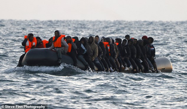 A group of up to fifty migrants are seen making the journey in a large boat across the English Channel.