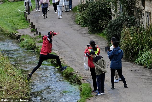 Another photo shows a man jumping over a narrow stream while one of his companions appears to capture the moment on camera.