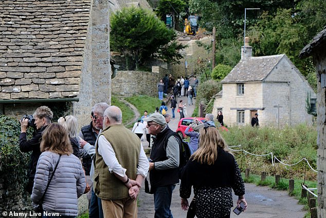 These photos show visitors in the village of Bibury in Gloucester on Friday.