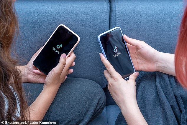 Two phones charge TikTok. A student admitted to her teacher that she spends six hours a day on the app (file image)