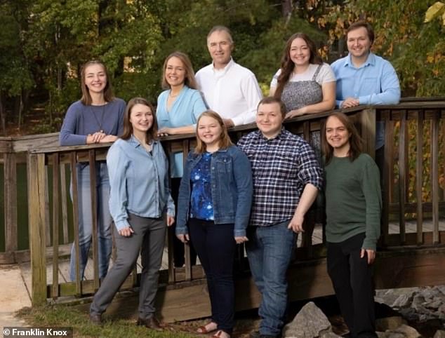 Mr Stewart, pictured with his wife Jen and their seven children.