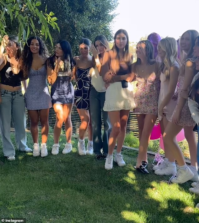 Fiona and her friends grouped together for a memorable photo as they all stood under the shade of a tree in what appeared to be a spacious backyard.