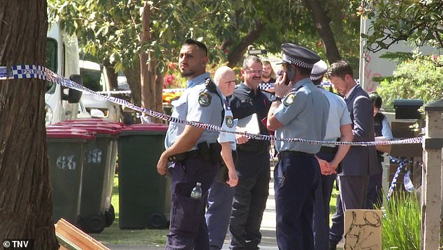 New South Wales police officers are seen at the scene of the shooting in western Sydney.