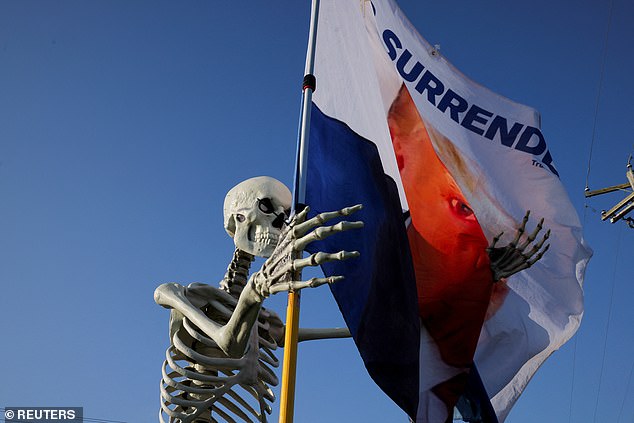 A Halloween decoration next to a flag in support of Republican presidential candidate, former US President Donald Trump, on the day Trump returns to the site of the assassination attempt against him in July, in Butler, Pennsylvania, USA, October 5, 202