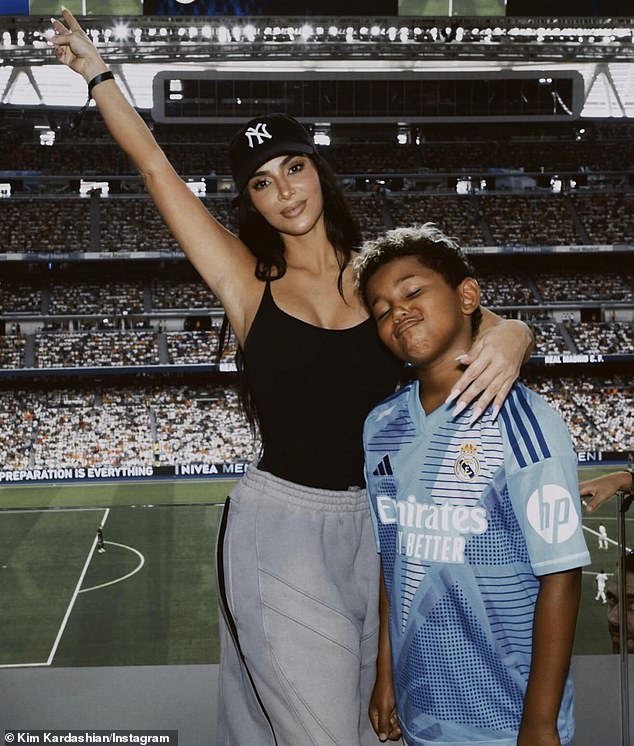 Kim appears with Saint in an Instagram photo she shared last month from her trip to Spain, during which she called herself a 'Madrid soccer mom.'