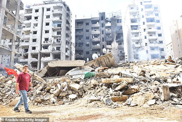 A man walks through the rubble of a building destroyed after the Israeli attacks in Dahieh.