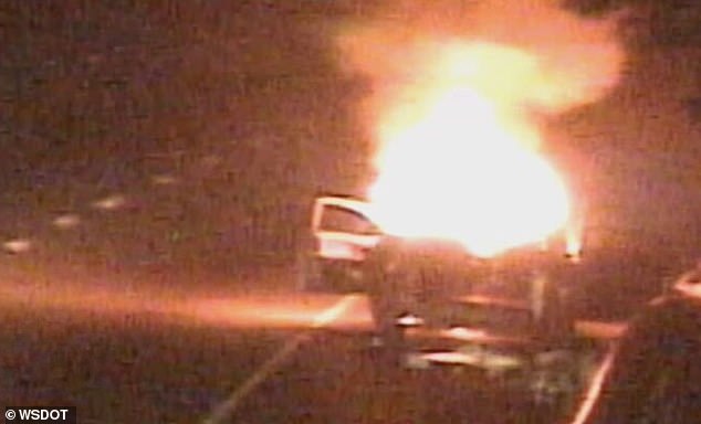 At one point, the driver walks even closer to the fire and opens the driver's side door.