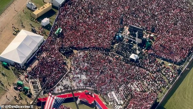 Video showed a crowd of people decked out in pro-Trump merchandise gathering around a stage as an American flag waved in the air.