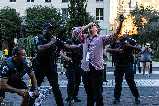 The journalist can be seen waving his burning arm in the air as he screams in pain. In the images, police officers cautiously approach Mena.